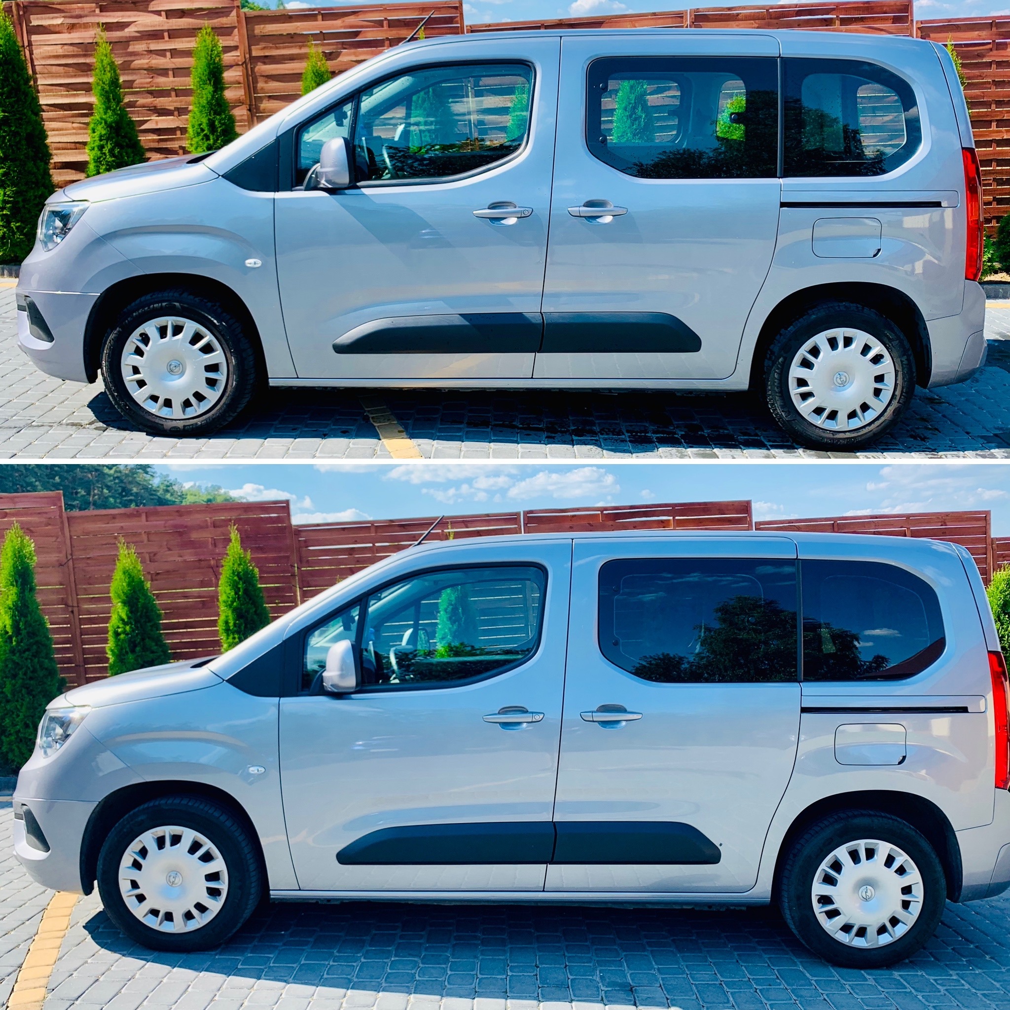 Srebrny samochód typu kombivan zaparkowany na brukowanej powierzchni, z widocznymi przyciemnionymi szybami tylnymi w porównaniu do szyb przednich, na tle drewnianego ogrodzenia i zielonych tuj.