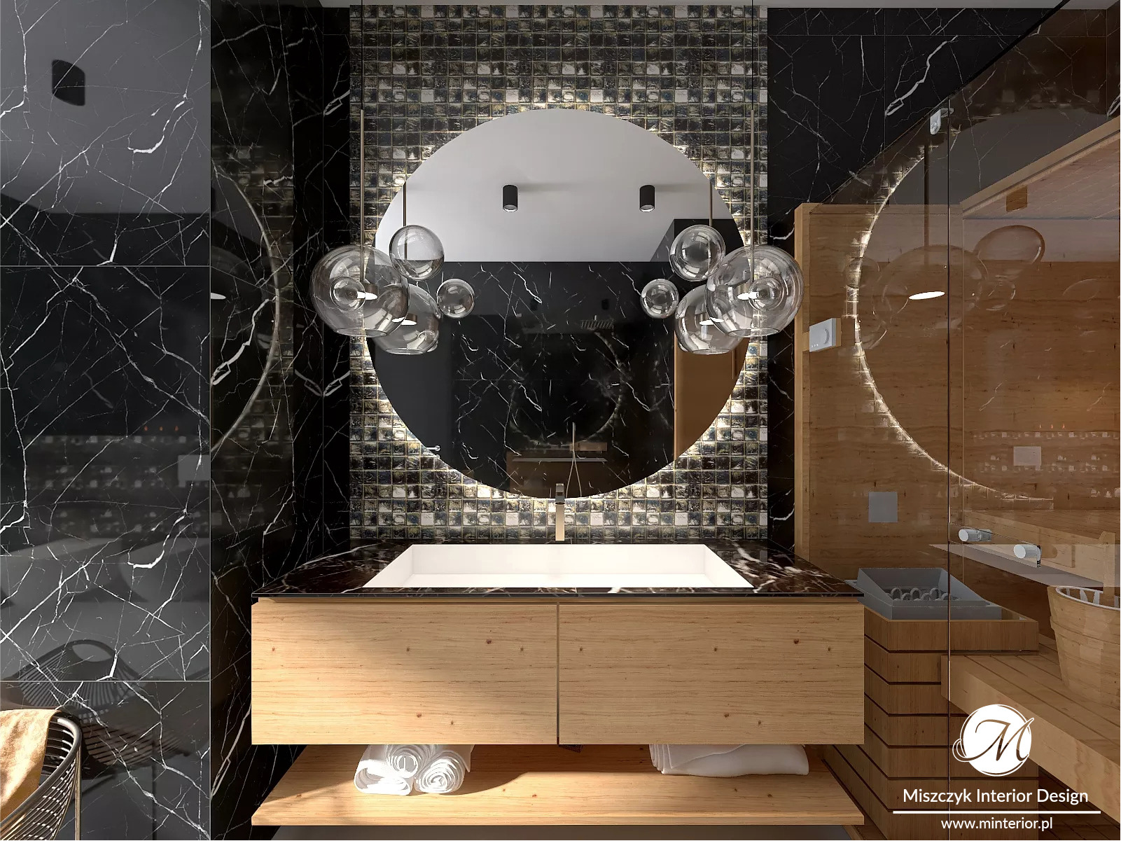Elegancka łazienka z czarnym marmurem, umywalką nablatową, drewnianą szafką i okrągłym lustrem podświetlanym mozaiką, z dekoracyjną lampą wiszącą z przezroczystych kul.