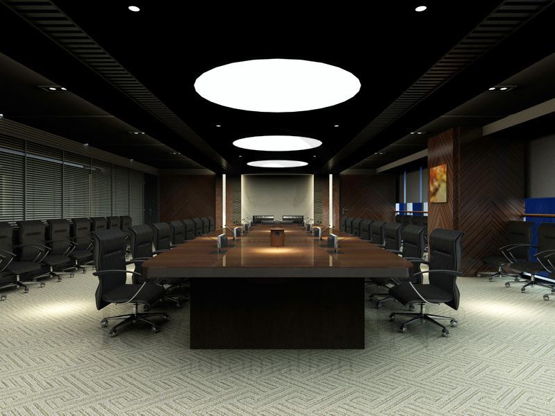 Nowoczesna sala konferencyjna z długim, ciemnym stołem, czarnymi krzesłami i okrągłymi lampami sufitowymi dającymi jasne, równomierne światło.