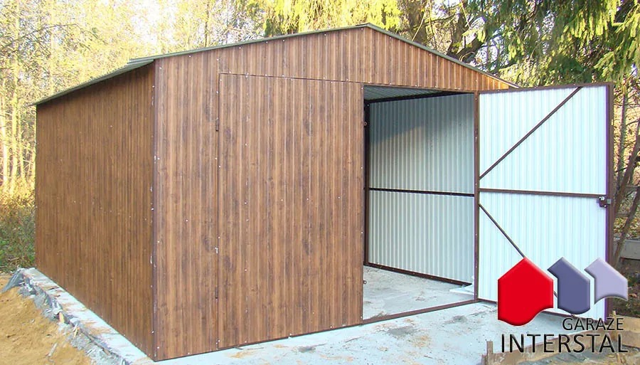 Brązowy garaż blaszany z otwartymi drzwiami, widoczne wnętrze z blachy falistej, na fundamencie betonowym, z logo firmy Interstal w prawym dolnym rogu.