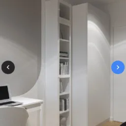 Wizualizacja pokoju z biurkiem, laptopem i wysoką, białą zabudową meblową z półkami na książki, uzupełniona o szafę z gładkimi frontami.