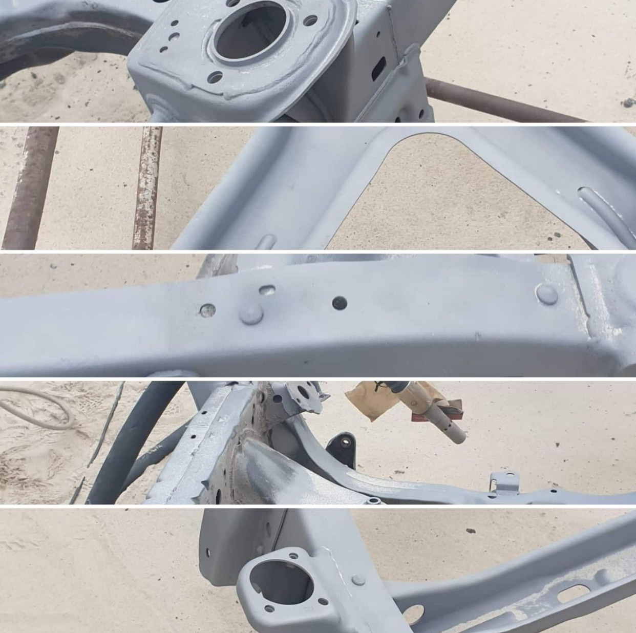 Fragmenty ramy samochodowej po obróbce, pokryte szarym podkładem, widoczne ślady spawania i otwory montażowe, przygotowane do dalszych prac lakierniczych.