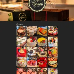 Ciemnobrązowe ciasto w kostkach z czerwoną polewą, udekorowane logo 'Milli Vanilli', obok pudełko z tym samym logo, w tle witryna cukiernicza.