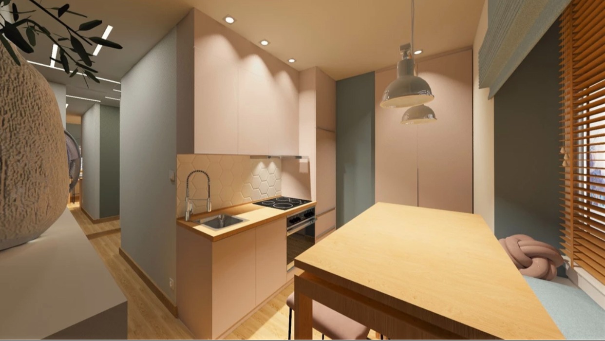 Wizualizacja wnętrza mieszkania z aneksem kuchennym w odcieniach różu i szarości, z drewnianym stołem i lampami wiszącymi w stylu industrialnym, oraz dekoracyjną poduszką w oknie.