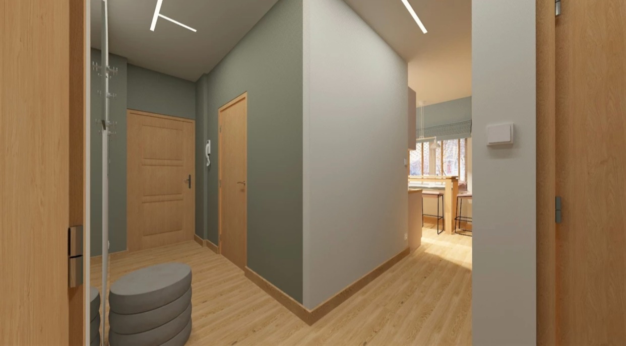 Wizualizacja przestronnego przedpokoju z drewnianą podłogą, szarymi ścianami, dwiema drewnianymi drzwiami, wieszakiem z lustrem i okrągłym siedziskiem. W tle widoczna kuchnia z oknem.