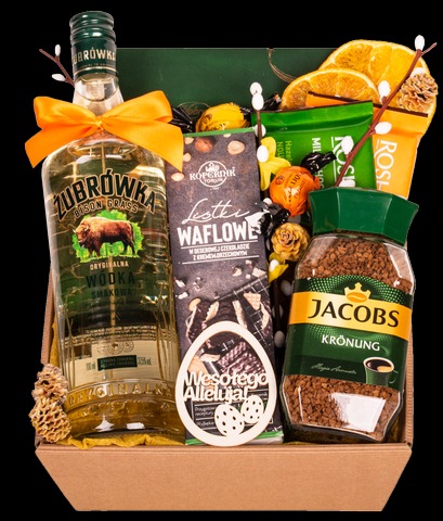 Kosz prezentowy z wódką Żubrówka, kawą Jacobs Krönung, waflowymi listkami Kopernik, suszonymi pomarańczami i czekoladkami, udekorowany drewnianą ozdobą wielkanocną.