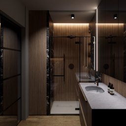 MG Studio Projektowania Wnętrz - Nowoczesna łazienka z kabiną prysznicową typu walk-in, drewnianymi panelami ściennymi i marmurowymi akcentami. Umywalka nablatowa z szarą armaturą i oświetleniem LED.
