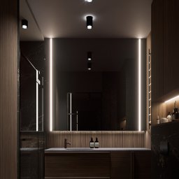 MG Studio Projektowania Wnętrz - Nowoczesna łazienka z ciemnego drewna i marmuru, oświetlona ledami. Umywalka z szafką, toaleta w minimalistycznym stylu, kabina prysznicowa ze szklanymi drzwiami.