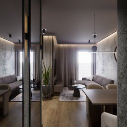 MG Studio Projektowania Wnętrz - Stylowe wnętrze mieszkania z drewnianą podłogą, dwoma sofami i stołem jadalnym, oświetlone nowoczesnymi lampami wiszącymi. Ściany zdobią delikatne, roślinne motywy.