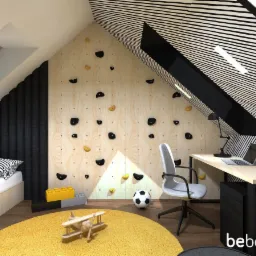 Pokój dziecięcy na poddaszu: ściana wspinaczkowa z czarnymi i żółtymi uchwytami, biurko z laptopem, krzesło obrotowe, łóżko z czarno-białą pościelą, dywan w kolorze słonecznego żółtego i drewniany...