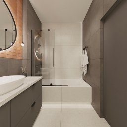 FUNKCJONALNE WNĘTRZE - studio projektowania wnętrz - Nowoczesna łazienka z owalnym lustrem z podświetleniem, szarą zabudową umywalki i kabiną prysznicową ze szklanymi drzwiami. Minimalistyczny design, neutralna kolorystyka.