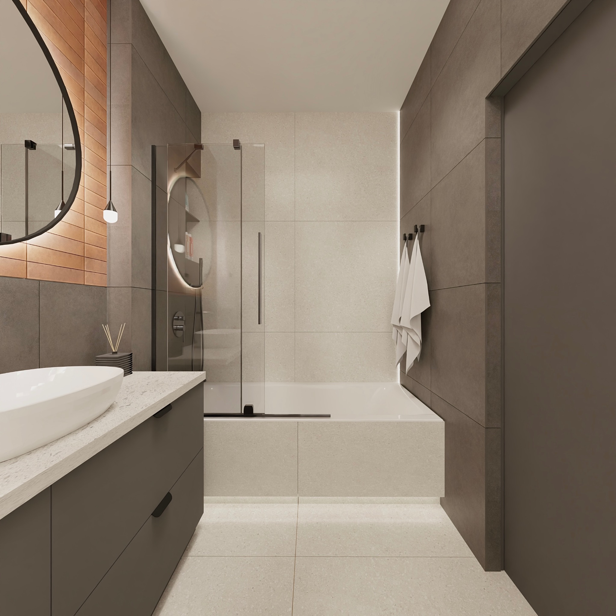 Nowoczesna łazienka z owalnym lustrem z podświetleniem, szarą zabudową umywalki i kabiną prysznicową ze szklanymi drzwiami. Minimalistyczny design, neutralna kolorystyka.