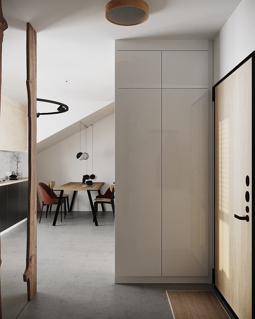 Minimalistyczny przedpokój z widokiem na jadalnię, szara szafa w zabudowie, drzwi wejściowe z drewnianym wykończeniem, betonowa podłoga i drewniany element dekoracyjny przy wejściu do jadalni.