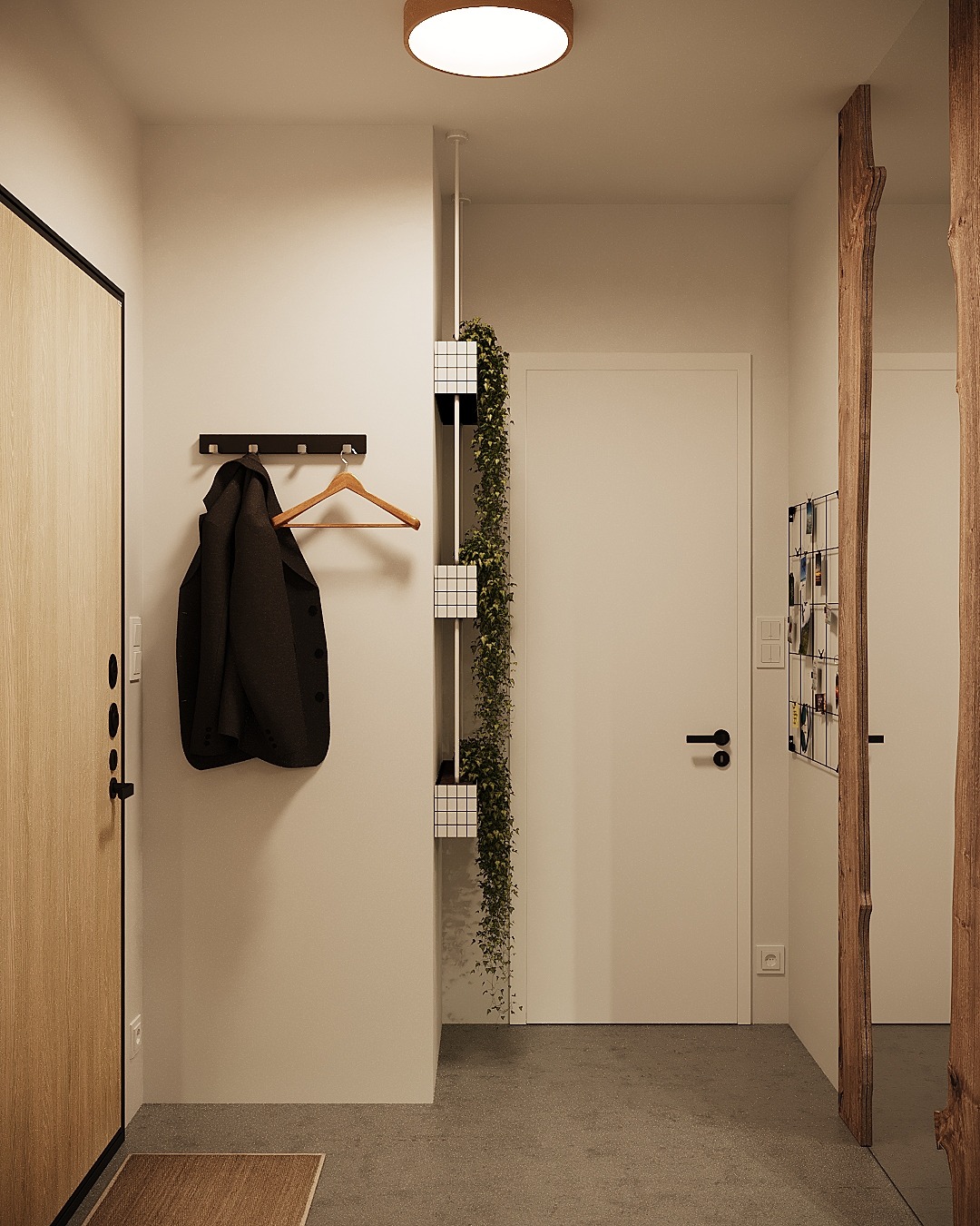 Nowoczesny przedpokój z drewnianymi akcentami: drzwi z jasnego drewna, wieszak z płaszczem na drewnianym wieszaku, pionowa donica z pnącą rośliną, dekoracyjna rama z surowego drewna.