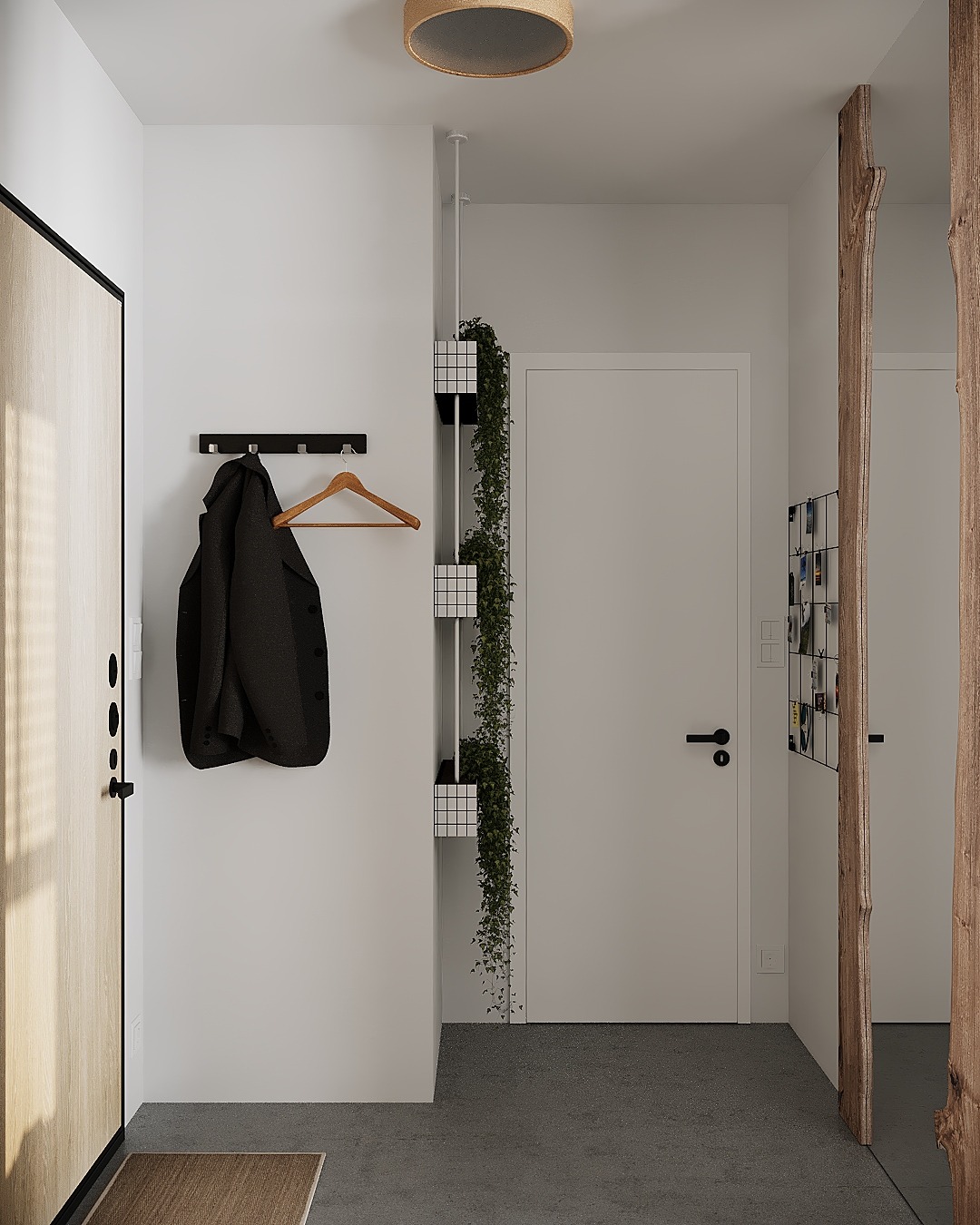 Minimalistyczny przedpokój z drewnianymi akcentami: płaszcz na wieszaku, pionowa donica z rośliną pnącą, drzwi z okleiną drewnopodobną i rama z surowego drewna.
