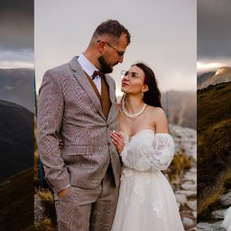 Kreatywna Fotografia Magdalena Saratowicz-BIałobok - Para młoda w górach: on w brązowym garniturze w kratę, ona w białej sukni z kwiatowymi aplikacjami, patrzą na siebie z czułością. Tło stanowią szczyty górskie.