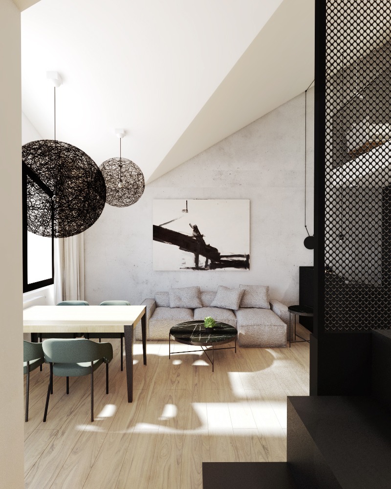 Jasne wnętrze mieszkania z drewnianą podłogą, szarą sofą narożną, okrągłym marmurkowym stolikiem kawowym, stołem jadalnym z zielonymi krzesłami i lampami wiszącymi w kształcie kuli z czarnej wikliny.