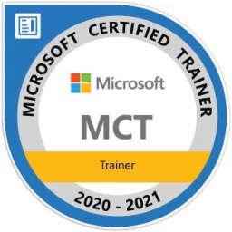 Okrągła odznaka Microsoft Certified Trainer (MCT) z lat 2020-2021, z logo Microsoft i napisem 'Trainer' na żółtym tle.