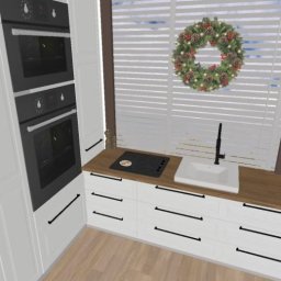 Ola kkk - Wizualizacja projektu kuchni w stylu skandynawskim z białymi szafkami, drewnianym blatem, wbudowanymi piekarnikami i świątecznym wieńcem na oknie.