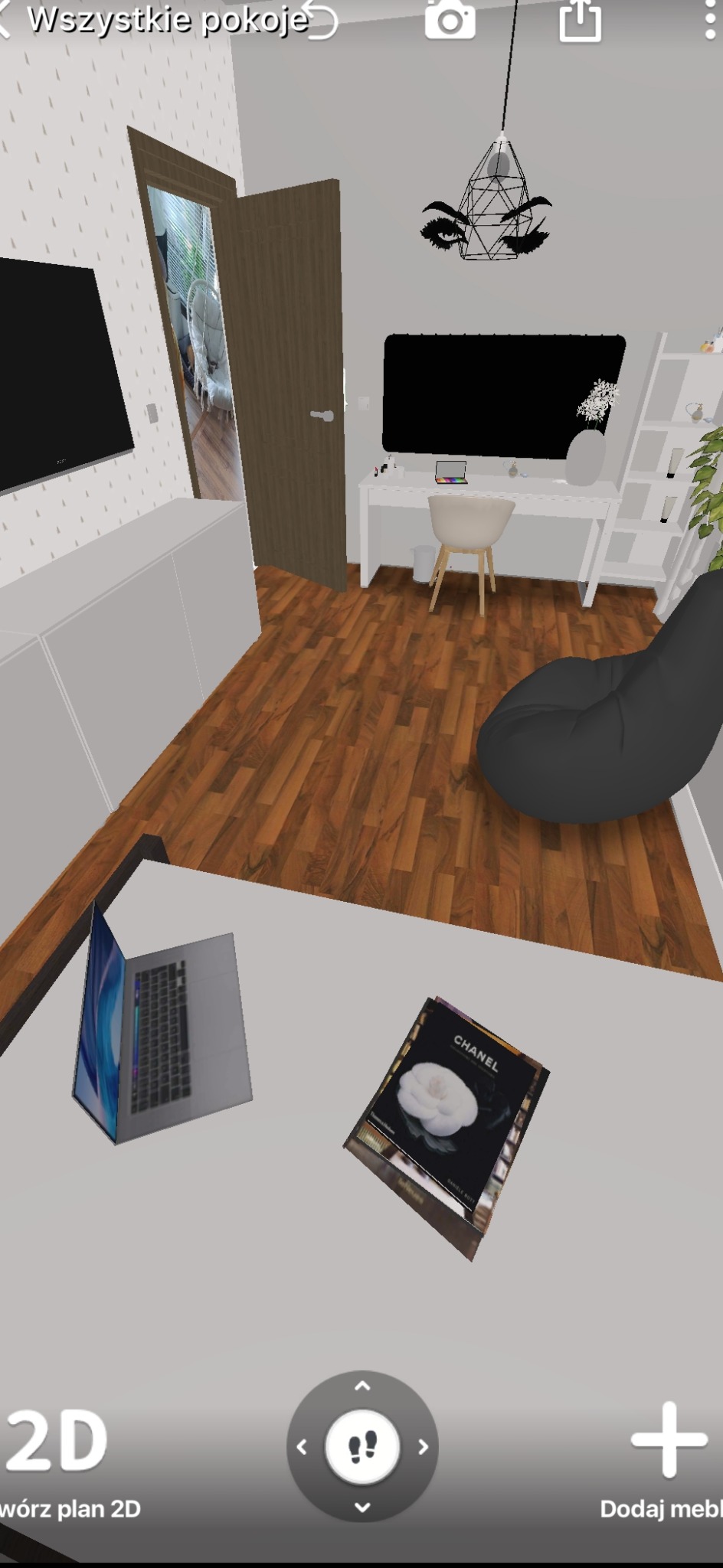 Wizualizacja pokoju z biurkiem, krzesłem, pufą, szafką RTV, lampą wiszącą i dekoracją ścienną w kształcie oka. Na pierwszym planie laptop i książka Chanel.