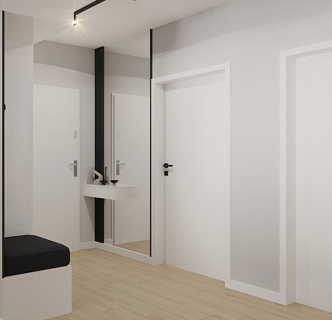 Minimalistyczny przedpokój z lustrem w czarnej ramie, białą konsolą i pufą. Jasne drewno na podłodze, białe ściany i drzwi. Oświetlenie punktowe.