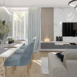 Wizualizacja jadalni z długim stołem nakrytym szarym bieżnikiem, krzesła tapicerowane w odcieniach błękitu, dekoracje roślinne, kominek bio w zabudowie pod telewizorem na tle ściany z marmurowym...