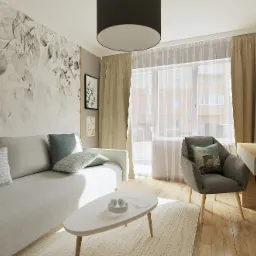 Jasny salon z szarą sofą, poduszkami w odcieniach zieleni i błękitu, białym stolikiem kawowym z słuchawkami, szarym fotelem z poduszką i biurkiem z komputerem, na ścianie fototapeta z motywem liści...