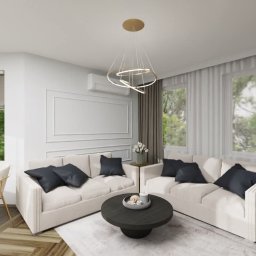 OLIV - Design projektowanie wnętrz Justyna Leszczyńska - Elegancki salon z dwoma białymi sofami, ciemnymi poduszkami i okrągłym stolikiem kawowym. Parkiet w jodełkę, nowoczesna lampa i duże okna z widokiem na zieleń.