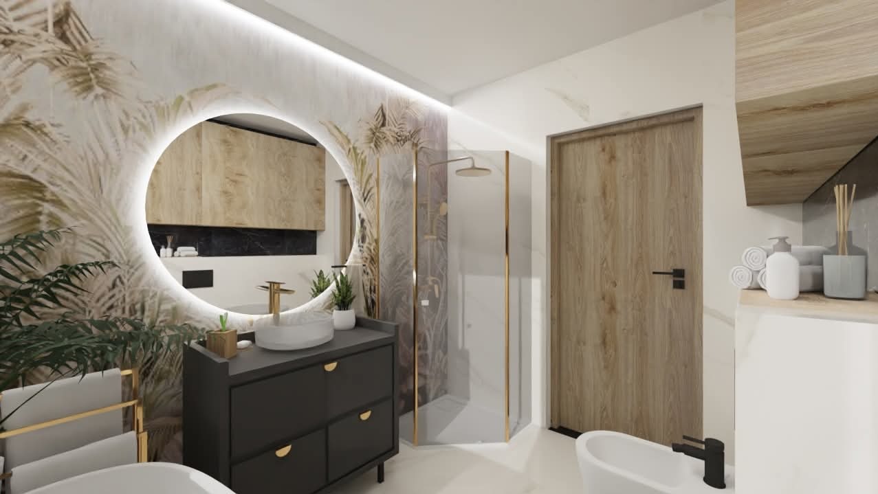 Nowoczesna łazienka z okrągłym lustrem LED, szafką w odcieniach szarości i kabiną prysznicową z złotymi akcentami, tapeta z motywem roślinnym.