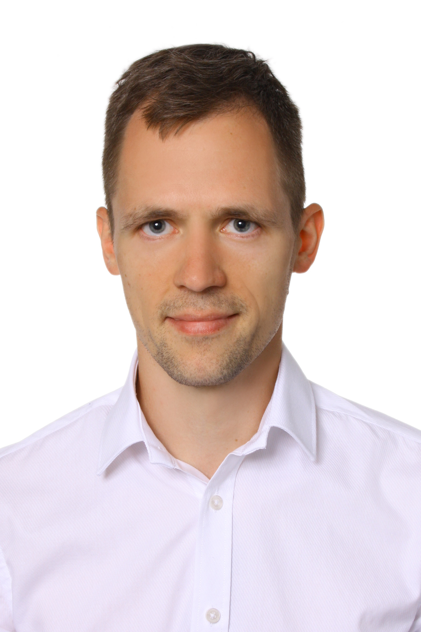 Portret mężczyzny w białej koszuli z kołnierzykiem na białym tle.