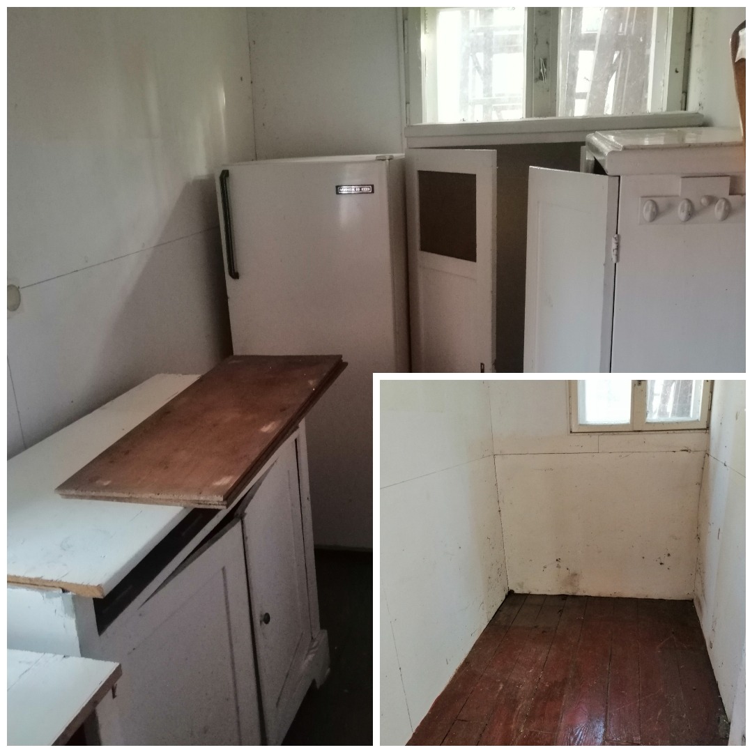 Wnętrze zaniedbanego pokoju z elementami starej kuchni: biała lodówka, szafki z blatem i drewniana podłoga, przygotowane do usunięcia.