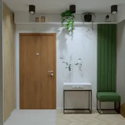 Nowoczesny przedpokój z drewnianymi drzwiami, minimalistyczną konsolą z białym blatem, zielonym panelem dekoracyjnym i roślinami zwisającymi z sufitu.