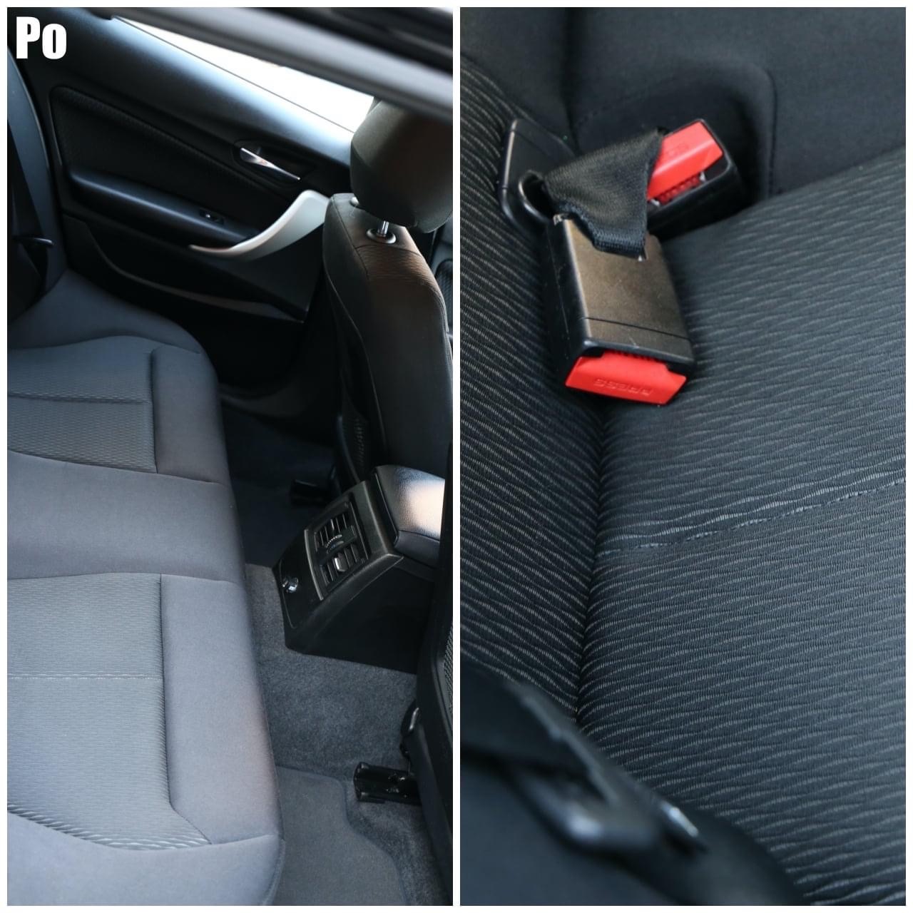 Wnętrze samochodu po odświeżeniu: tylna kanapa z szarej tkaniny, widoczne detale tapicerki i pasy bezpieczeństwa z czerwonymi elementami, kontrastujące z czystą powierzchnią.