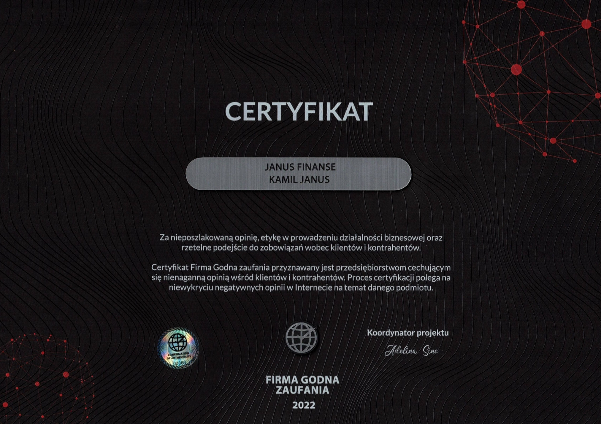 Certyfikat Firmy Godnej Zaufania 2022 dla Janus Finanse, potwierdzający etyczne prowadzenie działalności biznesowej i rzetelne podejście do klientów, z hologramem autentyczności i podpisem...
