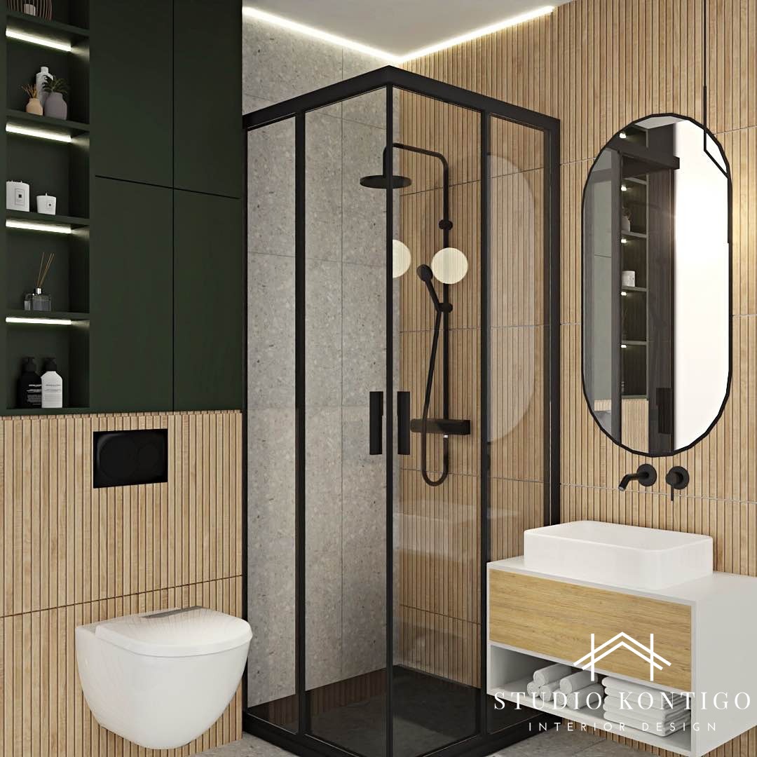 Nowoczesna łazienka z kabiną prysznicową typu walk-in z czarnymi profilami, owalnym lustrem z czarną ramą, wiszącą miską WC i szafką pod umywalką z drewnianym frontem.
