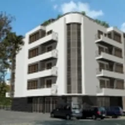 Wizualizacja budynku mieszkalnego z zaokrąglonym narożnikiem, białymi elewacjami, ciemnymi balustradami balkonów i przeszklonym parterem, otoczonego zielenią drzew i zaparkowanymi samochodami.