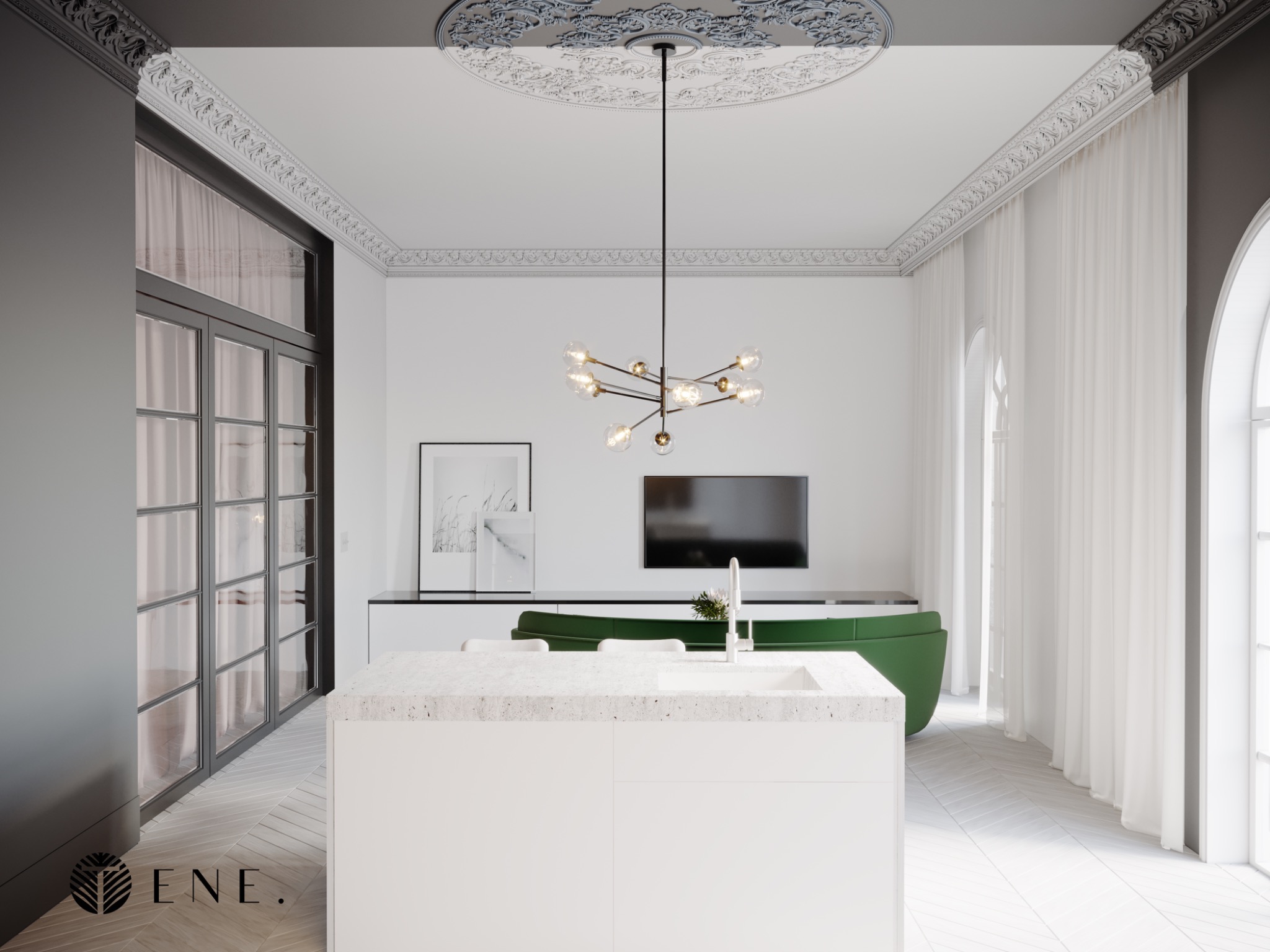 Wnętrze salonu z otwartą kuchnią, biała wyspa kuchenna z blatem imitującym lastryko, zielona sofa w tle, parkiet ułożony w jodełkę, dekoracyjne sztukaterie na suficie i ścianach, nowoczesna lampa...