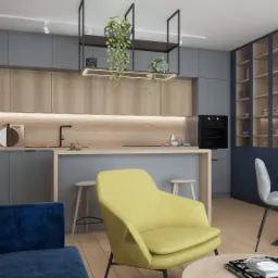 Nowoczesna kuchnia z wyspą, szarymi szafkami i drewnianymi akcentami, żółty fotel i niebieska sofa w salonie, wiszące rośliny nad wyspą, plakat z mapą Łodzi na ścianie w jadalni.