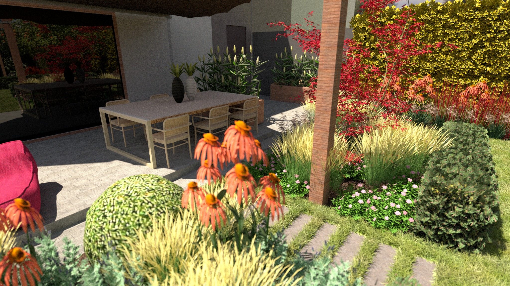 Nowoczesny ogród z kwitnącymi jeżówkami w odcieniach pomarańczy, ozdobnymi trawami i strzyżonymi krzewami, z meblami ogrodowymi w tle i czerwonymi akcentami roślinnymi przy ścianie.