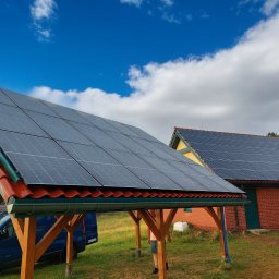 MyInstal - Instalacja paneli słonecznych na wiacie i budynku z czerwonej cegły, błękitne niebo z chmurami w tle. Widoczny samochód dostawczy.