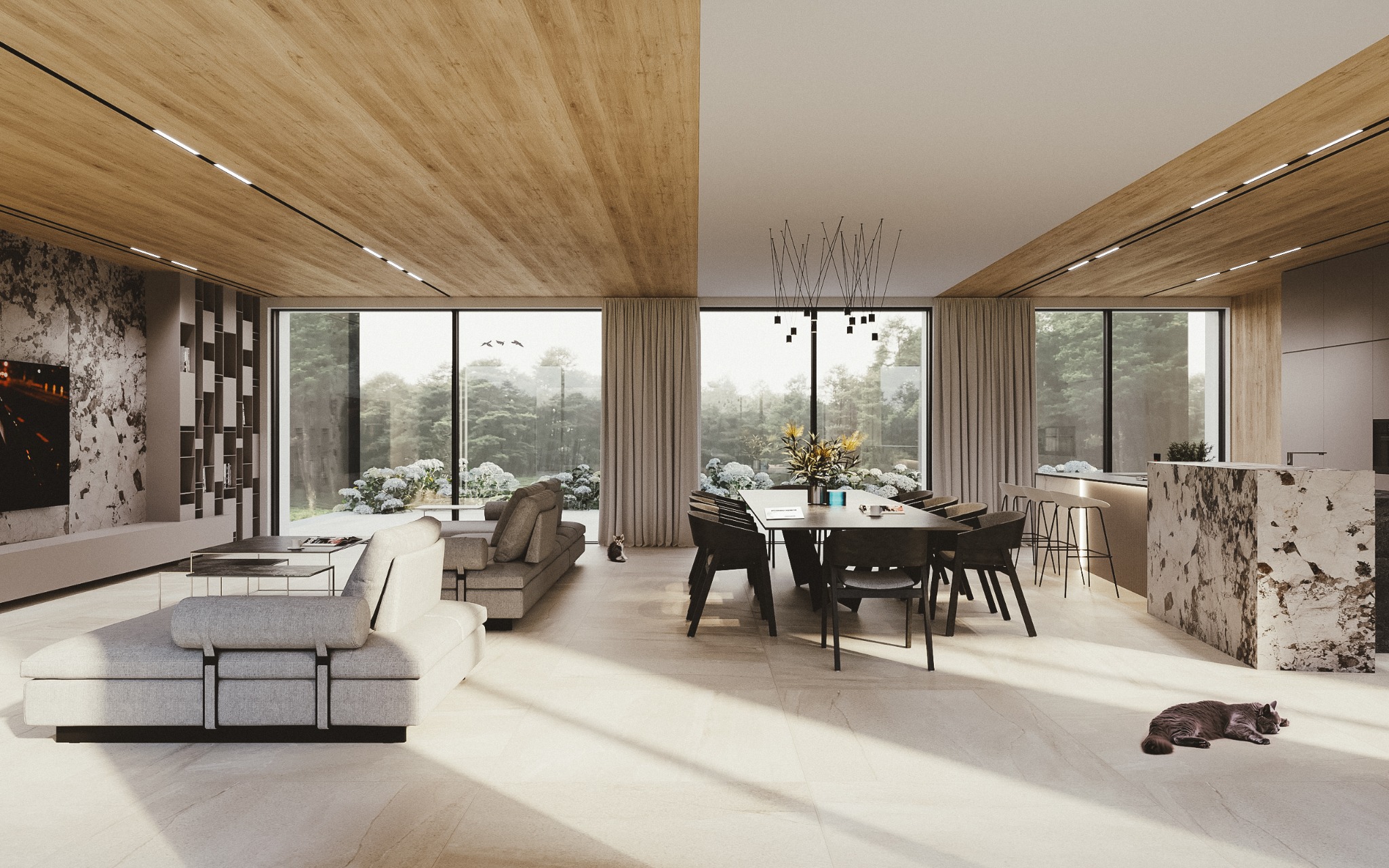 Jasne, przestronne wnętrze z drewnianym sufitem, dużymi oknami wychodzącymi na ogród, szarą sofą, stołem jadalnym z krzesłami, marmurową wyspą kuchenną i leżącym na podłodze kotem.