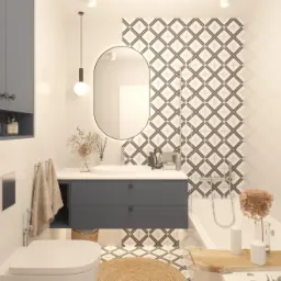 Nowoczesna łazienka w bieli i szarościach z okrągłym lustrem podświetlanym LED, wzorzyste płytki na ścianie i podłodze, niebieska szafka pod umywalką, pleciony dywanik i dodatki w stylu boho.