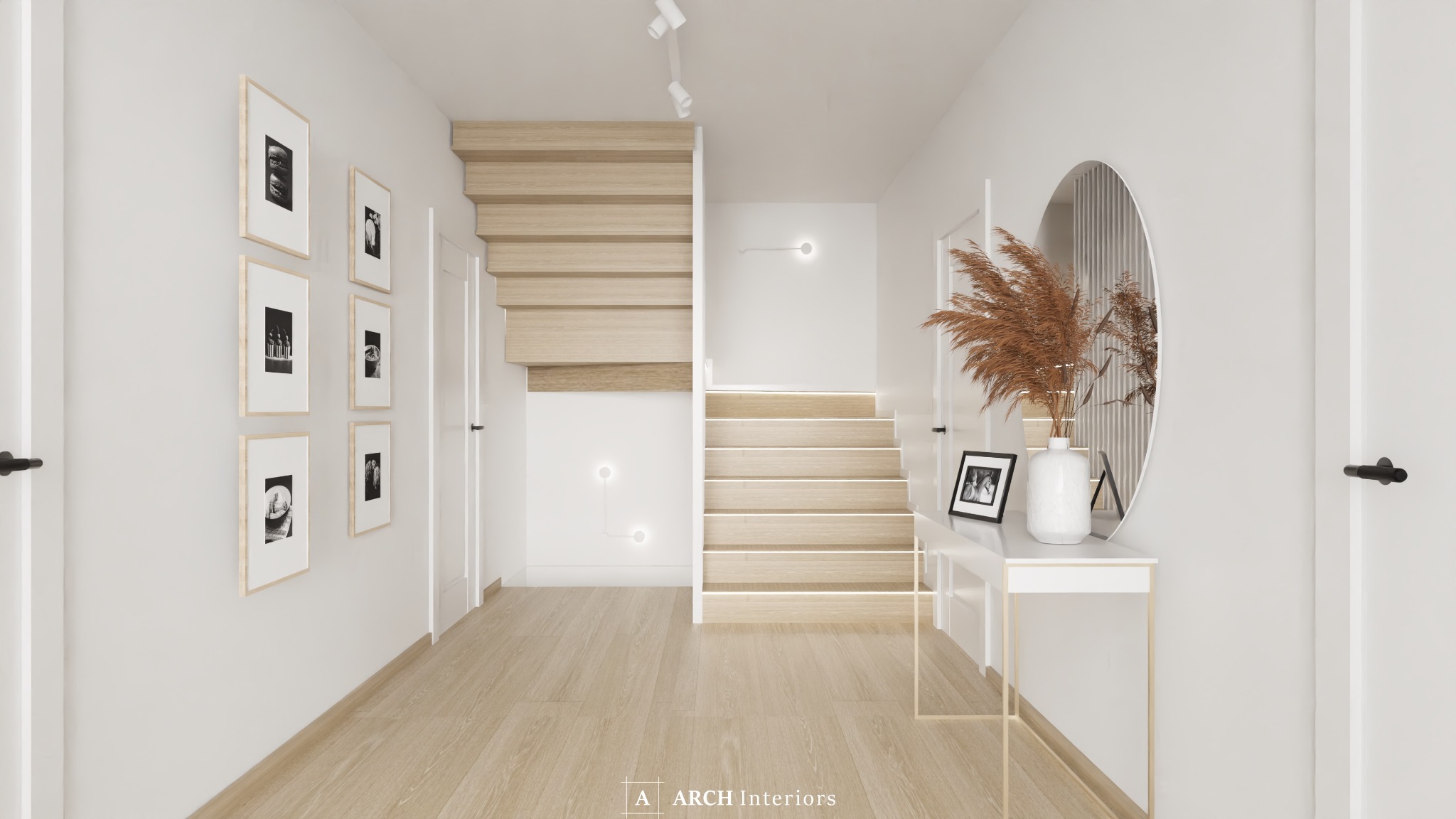 Nowoczesny przedpokój z drewnianymi schodami podświetlonymi ledami, galerią czarno-białych zdjęć w ramkach na ścianie i okrągłym lustrem nad białą konsolą z dekoracyjną trawą pampasową w wazonie.