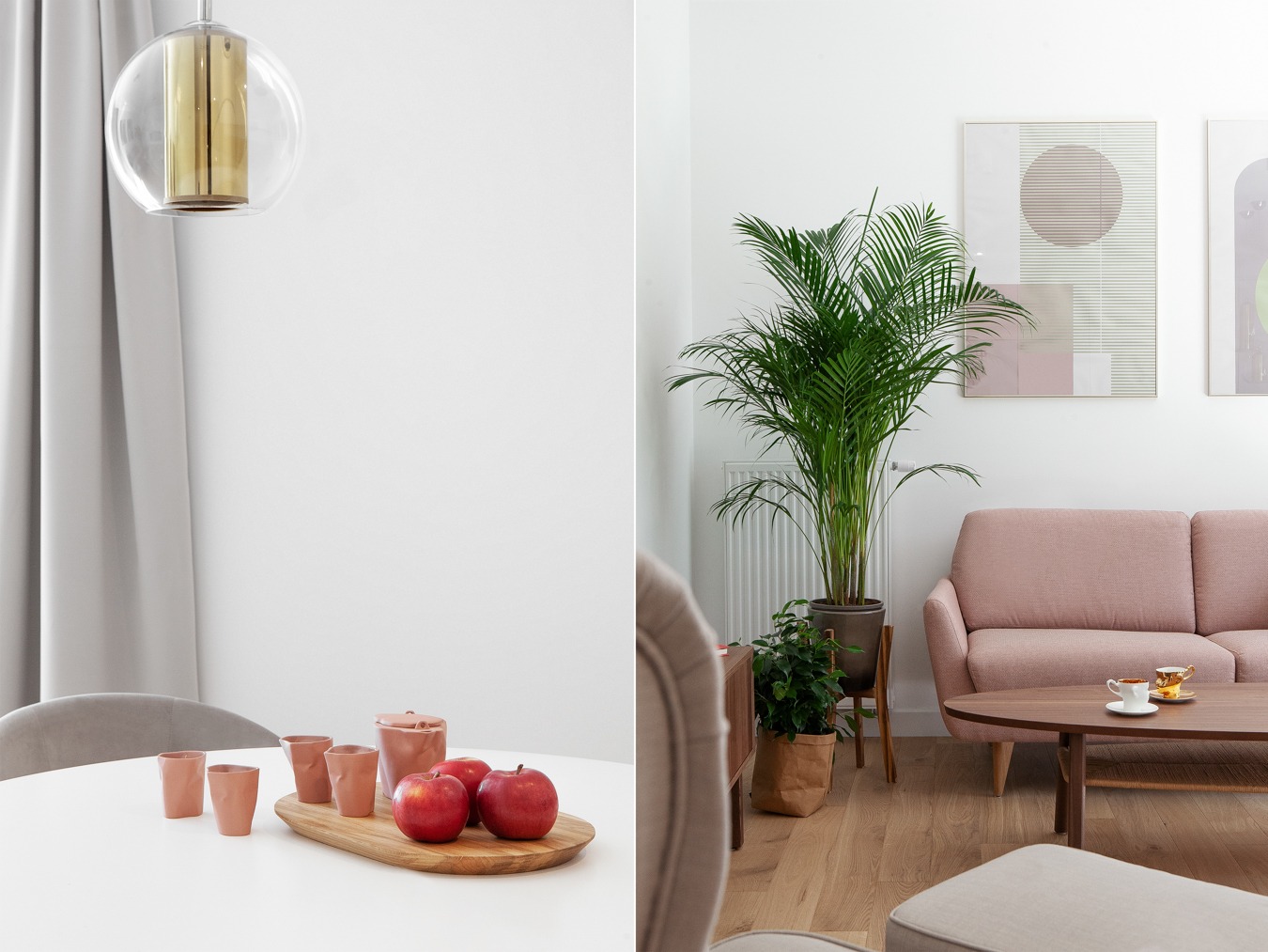 Jasne wnętrze mieszkania z okrągłym stołem, drewnianą deską z jabłkami i ceramicznymi naczyniami, oraz salonem z różową sofą, roślinami doniczkowymi i abstrakcyjnymi obrazami na ścianie.