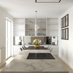 MD CONCEPT - Jasna kuchnia z wyspą wykończoną marmurem, szarymi szafkami i białymi półkami, stół z szarymi krzesłami i kwiatami w wazonie, nowoczesne obrazy na ścianie.