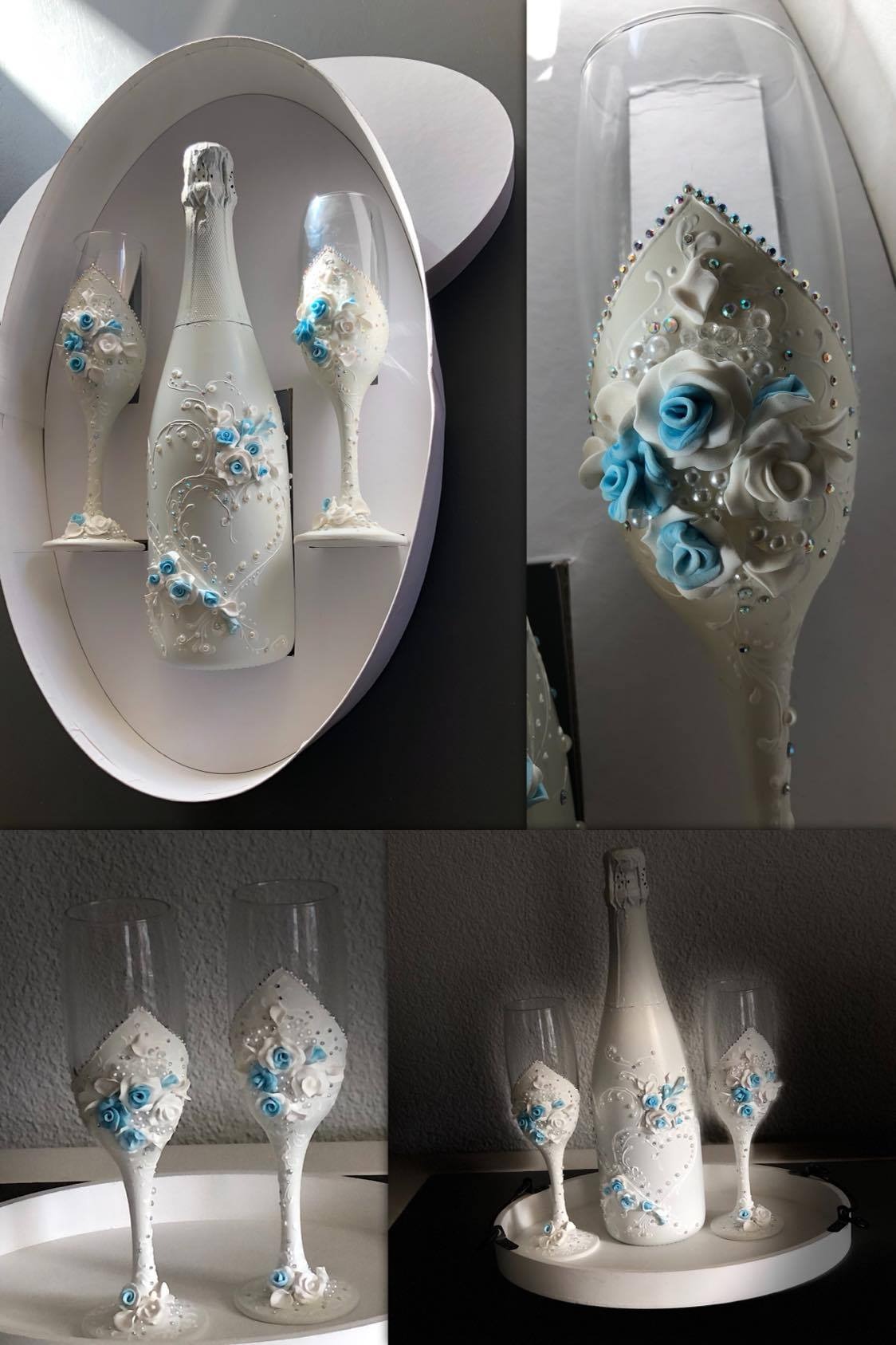 Zestaw prezentowy: biała butelka szampana i dwa kieliszki zdobione białymi i błękitnymi kwiatami z modeliny oraz drobnymi perełkami, umieszczone w białym, owalnym pudełku prezentowym w kształcie...