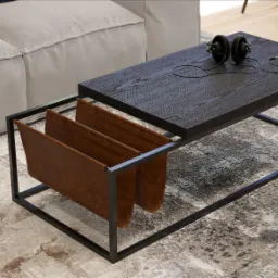 Nowoczesny stolik kawowy z ciemnym blatem, metalową ramą i skórzanymi przegródkami na czasopisma, obok jasnej sofy, z słuchawkami na blacie.