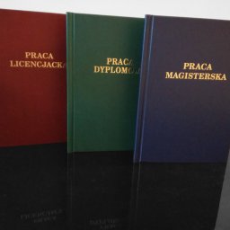 Powielarnia MADAS - Oprawione prace dyplomowe: licencjacka w bordowej oprawie, magisterska w granatowej i dyplomowa w zielonej, z tłoczonym złotym napisem na okładkach, ustawione rzędem na błyszczącej powierzchni.
