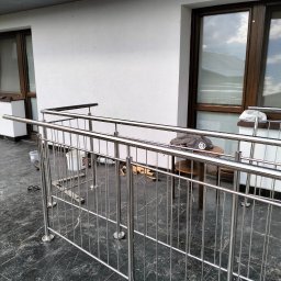 Tomasz Rekowski Firma Usługowa - Nowoczesna balustrada ze stali nierdzewnej, zamontowana na balkonie z marmurową posadzką, widoczne narzędzia pracy, wiadro z farbą i stolik z ubraniem.