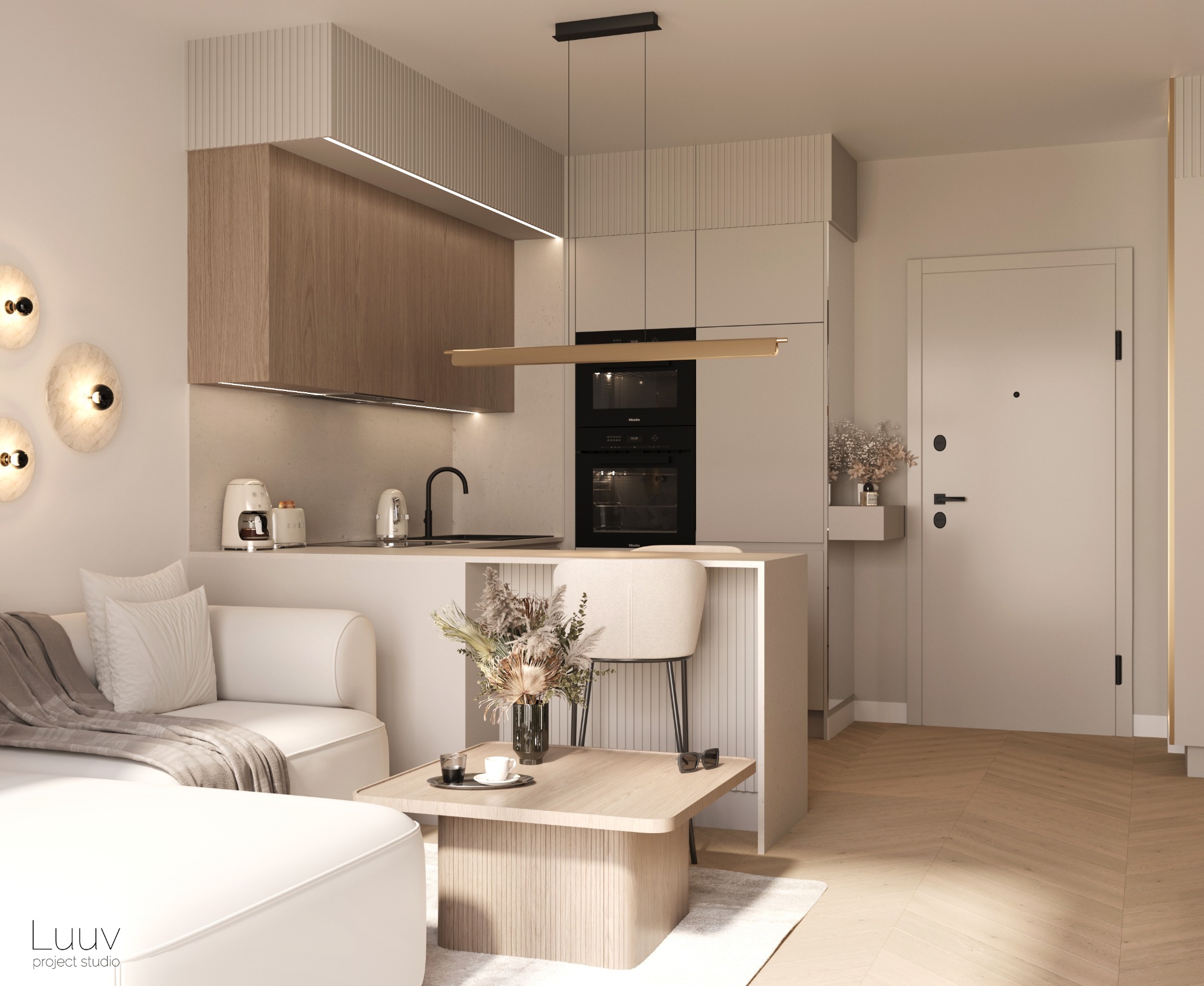 Wnętrze małego mieszkania w neutralnych barwach: beżowa sofa z narzutą, drewniany stolik kawowy z dekoracyjnym bukietem, aneks kuchenny z drewnianymi szafkami i czarnym piekarnikiem Miele,...